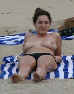 Kelly Brook sunbathing topless on a beach