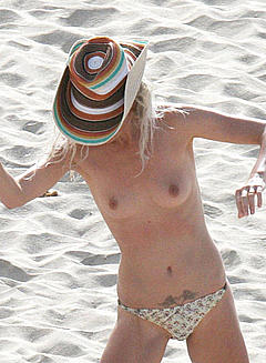 Laeticia Hallyday topless on a beach