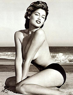 French actress Laetitia Casta topless on a beach mag scan