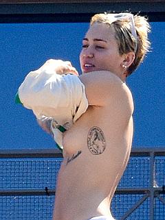 Miley Cyrus topless on a balcony