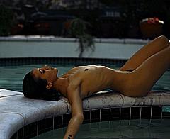 Nicole Branch lying fully nude poolside