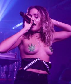 Tove Lo performs topless on a stage
