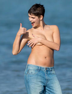 Pixie Geldof topless in jeans on a beach cover her tits