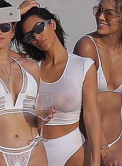 Kim Kardashian in wet transparent shirt at the beach