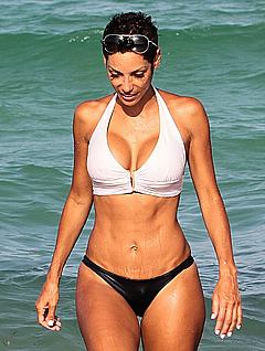 Nicole Murphy in black pants and white bikini top