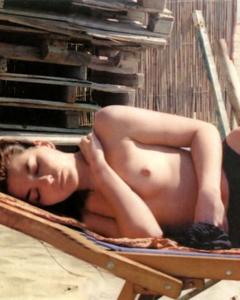 Vanessa Gravina sunabthing topless on a beach