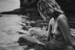 Bridie Morris naked in a water black-&-white image
