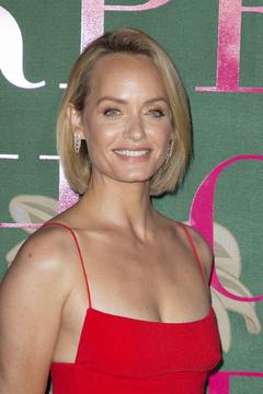 Amber Valletta in red dress at Green Carpet Fashion Awards in Milan