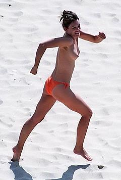 Elizabeth Hurley topless on a beach