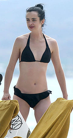 Krysten Ritter in black bikini on a beach