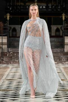 Lilly Krug in see through dress walking the runway at the La Metamorphose Fashion Show in Paris