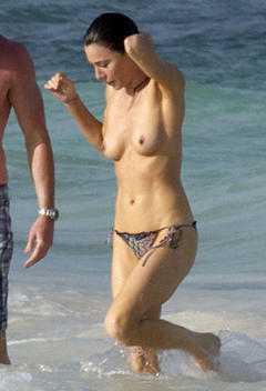 British actress Jaime Murray topless on a beach paparazzi photo