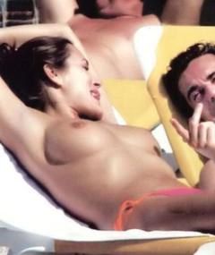 Alena Seredova sunbathing topless on a beach with honey