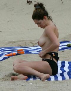 Kelly Brook topless on a beach paparazzi photo