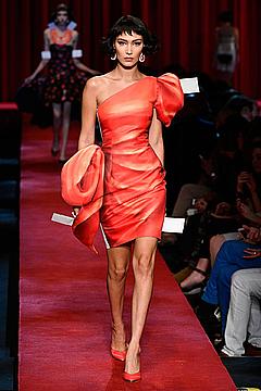 Bella Hadid in orange dress runway photo