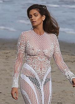 Supermodel Cindy Crawford topless under transparent fishnet dress