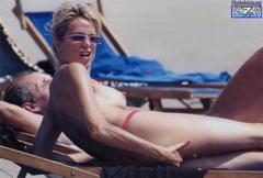 Silvia Rocca sunbathing topless on a beach