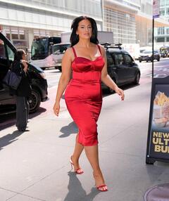 Ashley Graham in red dress arriving at Planet Hollywood in New York - April 2025