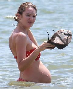 Pregnant Candice Swanepoel in bikini in ocean