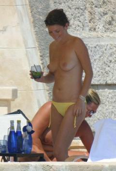 Anna Friel topless with drink on a beach