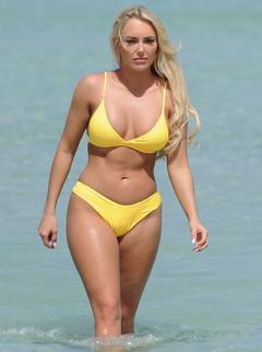 Amber Turner in yellow bikini on a beach