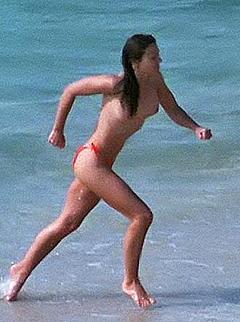 Elizabeth Hurley topless on a beach