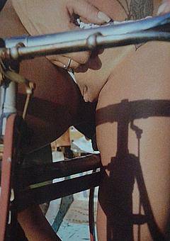 Rafaela Ravena on a bicycle shows shaved pussy