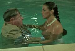 Serena Grandi topless in a pool at Roba da ricchi