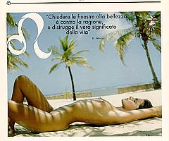 Alessia Merz lying naked on a beach