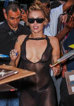 Miley Cyrus braless in see through dress arrives to her hotel this evening in New York City - June 2025