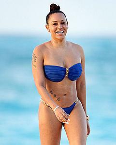 Melanie Brown in blue bikini on a beach