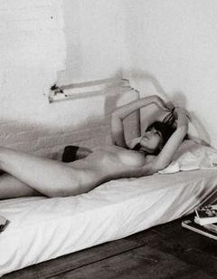 Daisy Lowe lying nude on a bed