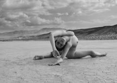 Nina Burri doing yoga nude in a desert