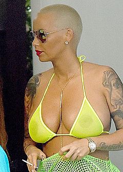 Amber Rose in yellow bikini top by the pool in Miami Beach