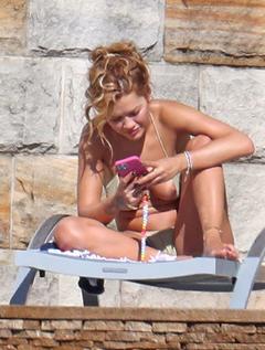 Rita Ora nipple slip in bikini by the pool in Sydney