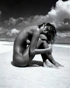 Eva Herzigova wet and naked on a beach