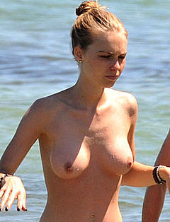 Katharina Damm topless on a beach