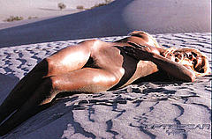 Manuela Kemp lying fully nude in a desert