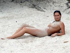 Lucy Clarkson lying naked on a beach