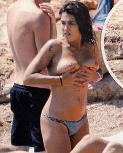 Spanish actress Lorena Castell shows her nude tits on a beach paparazzi photo