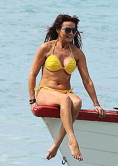 Lizzie Cundy in yellow bikini on a boat in Barbados