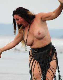 Lisa Appleton topless on a beach
