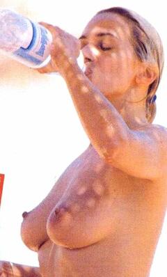 Barbara D'Urso topless on a beach paparazzi image